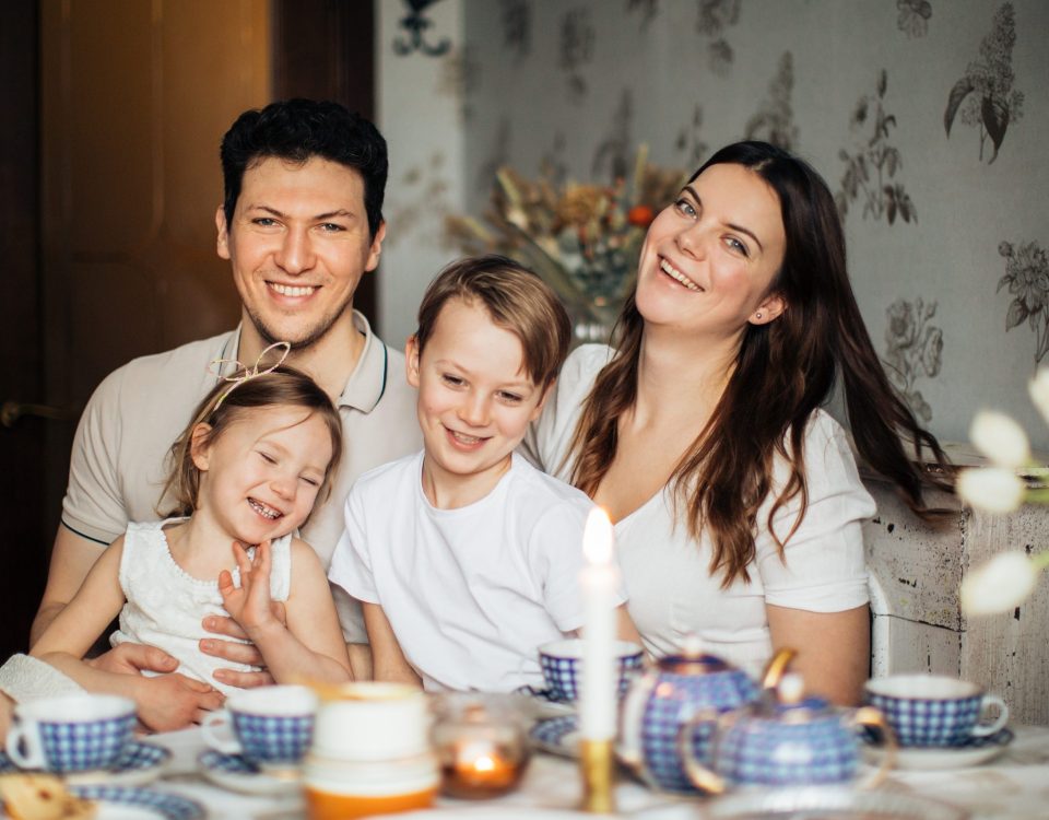 Una familia sonriente y unida compartiendo una bebida, disfrutando de momentos de felicidad y conexión en sus relaciones familiares